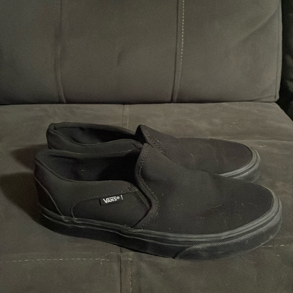 Black Vans slip-on sneakers